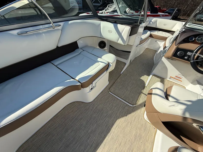 Slide: The Image of Interior of a 2015 Cobalt 220S boat with beige and white seating. - 24