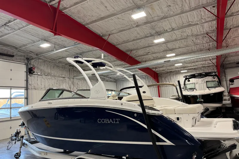 Slide: The Image of 2015 Cobalt R5 boat in a warehouse, featuring sleek design and modern amenities. - 4