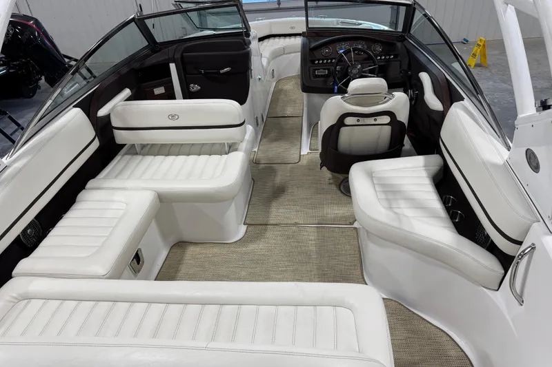 Slide: The Image of Interior of a 2015 Cobalt R5 boat with white leather seating and modern dashboard. - 7