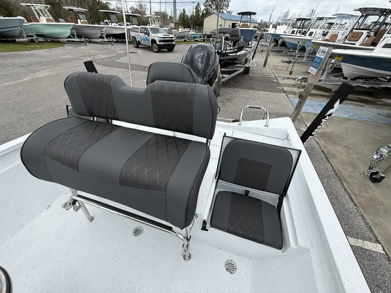 Slide: The Image of 2026 Xpress H20B Bay boat with gray seats outdoors. - 11