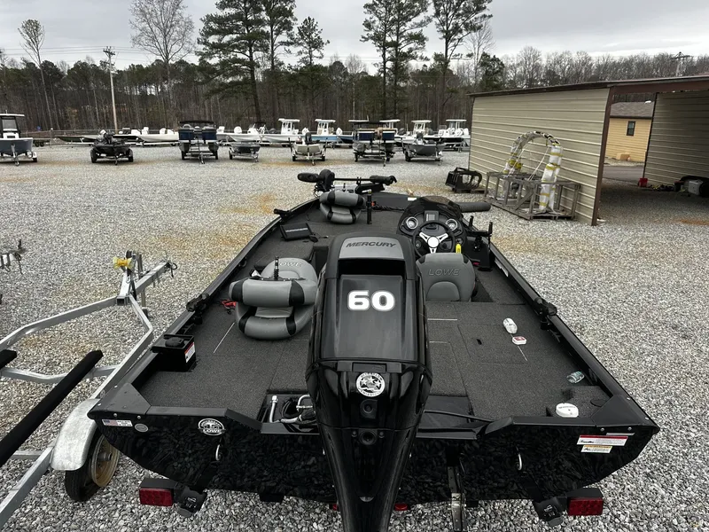 Slide: The Image of 2016 Lowe Stinger ST175 boat with Mercury engine on gravel lot. - 2