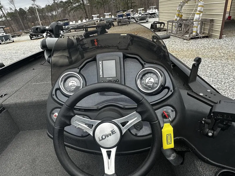 Slide: The Image of 2016 Lowe Stinger ST175 boat console with controls and gauges. - 7