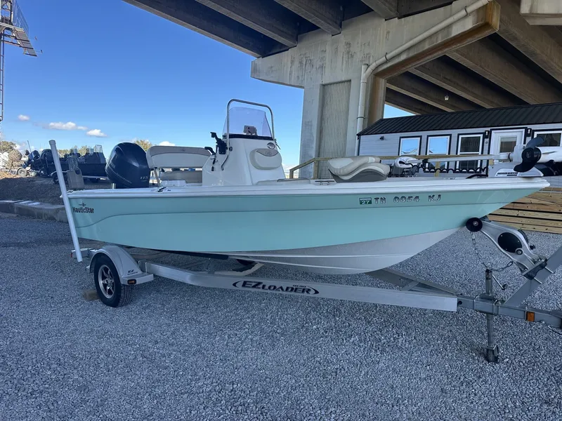 Slide: The Image of 2018 NauticStar 1810 NauticBay boat on trailer under bridge. - 2