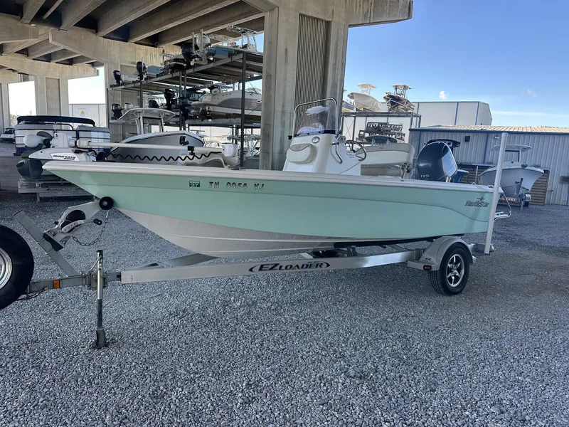 Slide: The Image of 2018 NauticStar 1810 NauticBay boat on trailer under bridge. - 7