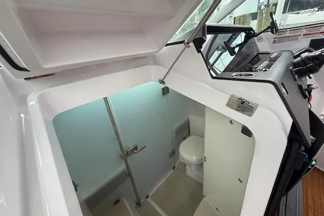 Slide: The Image of 2024 Axopar 37 Sun-Top boat interior with modern bathroom and sleek design. - 16