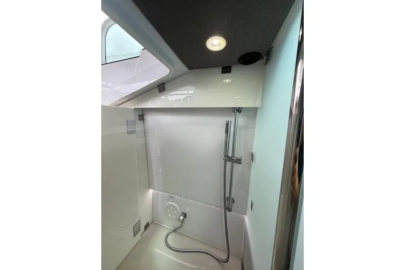 Slide: The Image of 2024 Axopar 37 Sun-Top interior shower with modern fixtures and sleek design. - 18