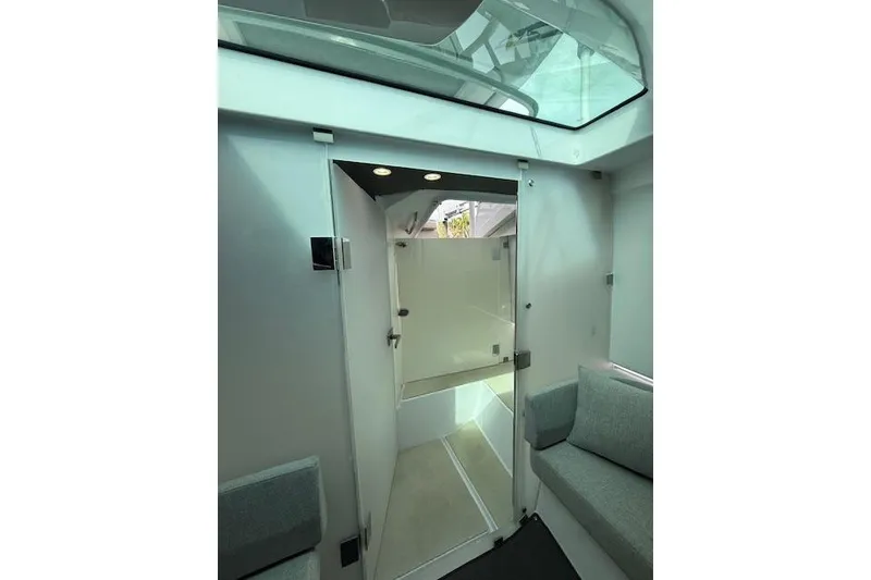 Slide: The Image of Interior view of 2024 Axopar 37 Sun-Top boat with skylight and seating area. - 19