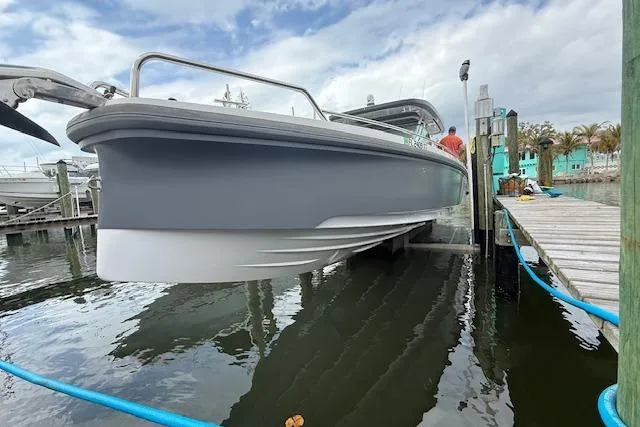 Slide: The Image of 2024 Axopar 37 Sun-Top boat docked, showcasing sleek design and modern features. - 3