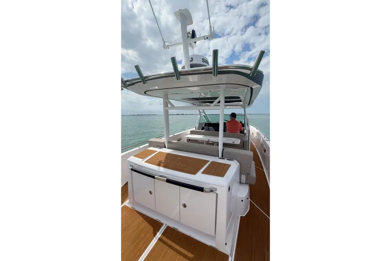 Slide: The Image of 2024 Axopar 37 Sun-Top boat on water, featuring spacious deck and modern design. - 6