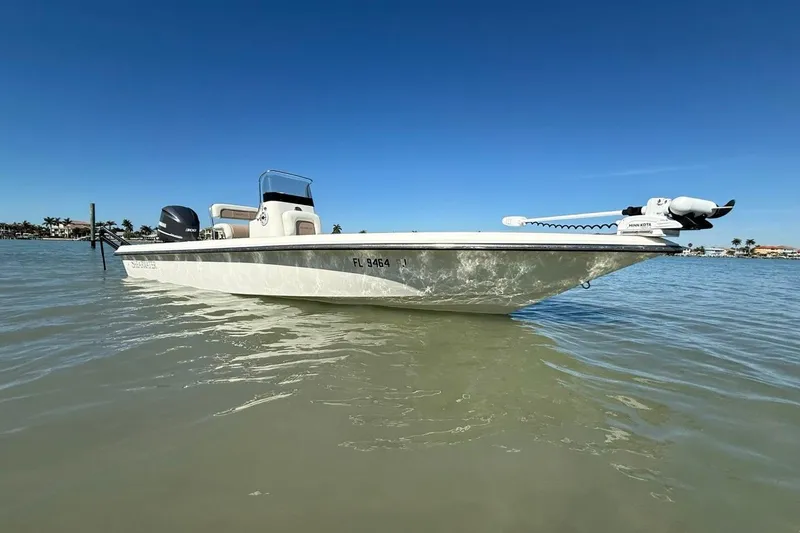 The Image of 2012 ShearWater 25 LTZ boat on calm water under clear blue sky. - 1