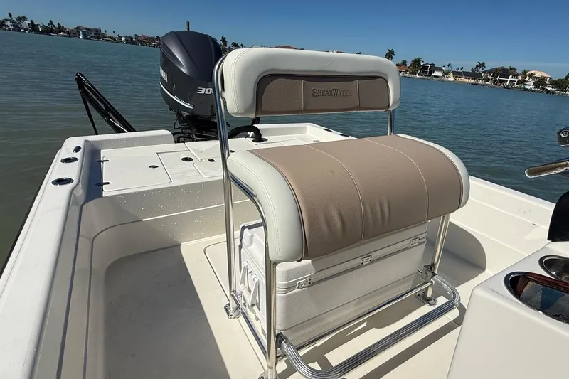 Slide: The Image of 2012 ShearWater 25 LTZ boat interior with seating and Yamaha outboard motor. - 10