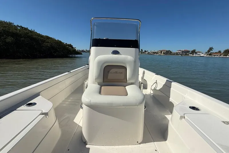 Slide: The Image of 2012 ShearWater 25 LTZ boat interior with seating, on calm water. - 14