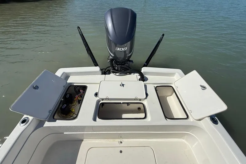 Slide: The Image of 2012 ShearWater 25 LTZ boat with open storage compartments and powerful outboard motor. - 21