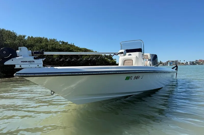 Slide: The Image of 2012 ShearWater 25 LTZ boat on calm water, featuring Minn Kota trolling motor. - 4