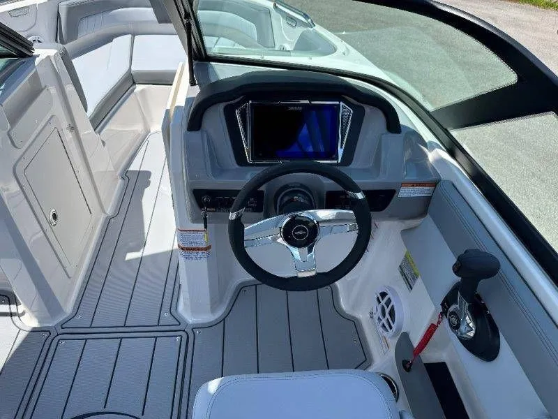 Slide: The Image of Interior of 2026 Chaparral 21 SSi with steering console and seating area. - 33