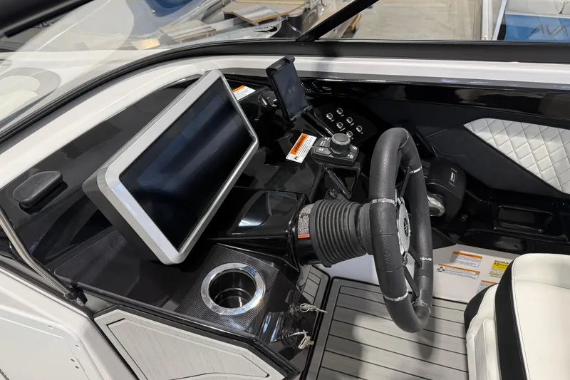 Slide: The Image of 2025 Yamaha Boats 252S cockpit with modern steering and touchscreen display. - 5