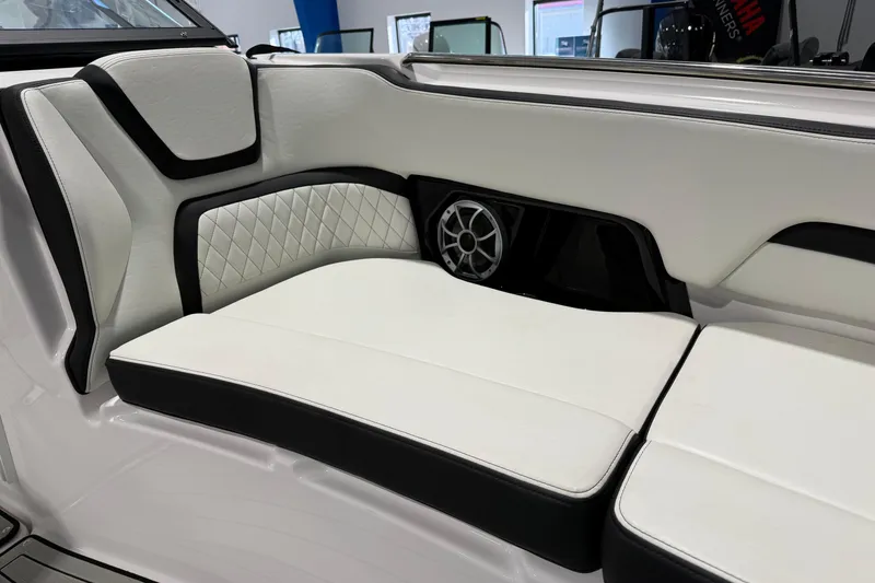 Slide: The Image of 2025 Yamaha Boats 252S interior seating with white upholstery and speaker detail. - 7