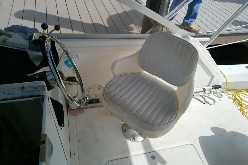 Slide: The Image of Captain's seat and steering wheel of a 1996 Shamrock 260 Express boat. - 15