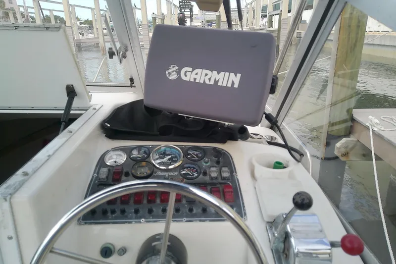 Slide: The Image of 1996 Shamrock 260 Express boat dashboard with Garmin navigation system. - 18