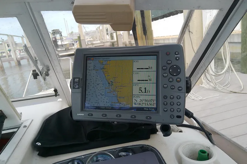 Slide: The Image of Garmin GPS on 1996 Shamrock 260 Express boat, displaying navigation data and map. - 20