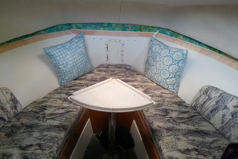 Slide: The Image of Interior cabin of a 1996 Shamrock 260 Express boat with patterned cushions and pillows. - 23