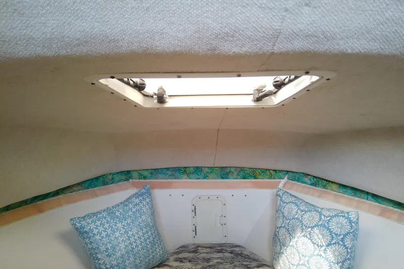 Slide: The Image of 1996 Shamrock 260 Express cabin interior with skylight and decorative pillows. - 26