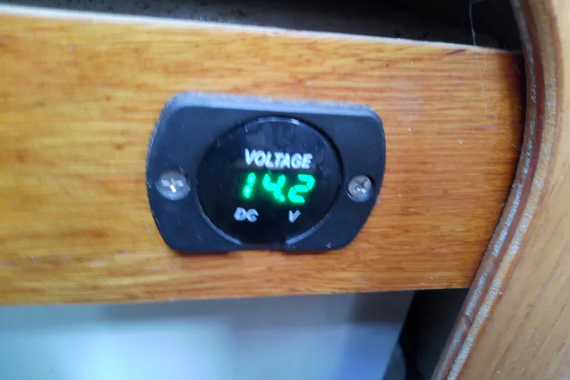 Slide: The Image of Voltage meter reading 14.2V on 1996 Shamrock 260 Express boat dashboard. - 33
