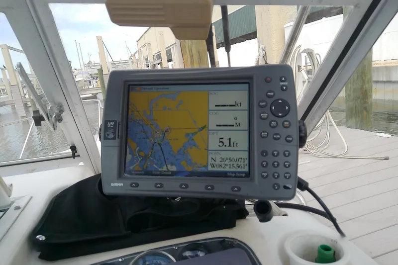 Slide: The Image of GPS navigation system on a 1996 Shamrock 260 Express boat, docked at a marina. - 19