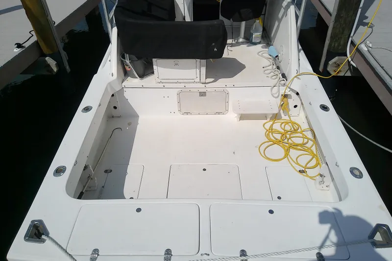 Slide: The Image of 1996 Shamrock 260 Express boat deck with seating and coiled yellow cable. - 7