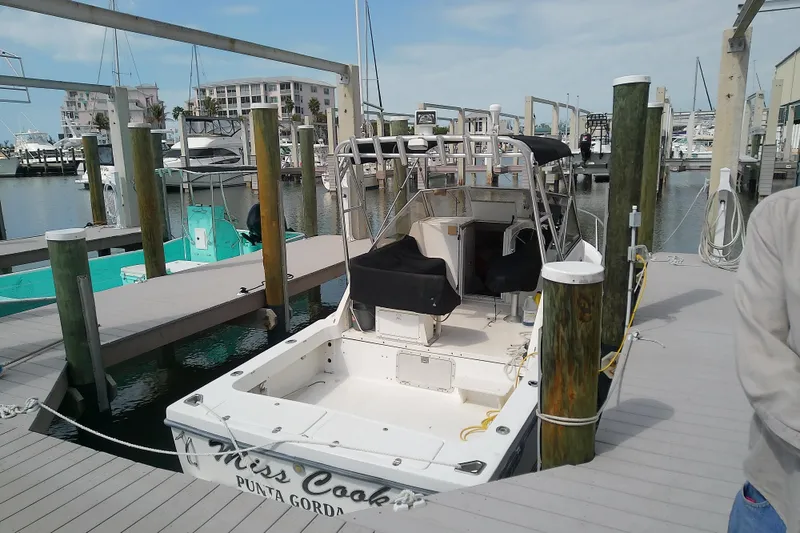 Slide: The Image of 1996 Shamrock 260 Express boat docked at marina in Punta Gorda. - 2