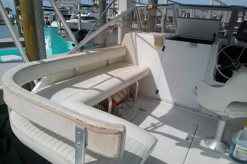 Slide: The Image of 1996 Shamrock 260 Express boat interior with seating and steering wheel. - 13