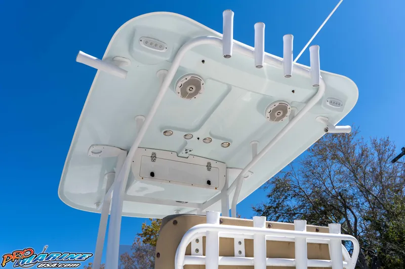 Slide: The Image of 2017 Sea Hunt Ultra 235 SE boat top view with rod holders and speakers against blue sky. - 19