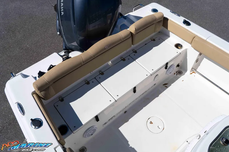 Slide: The Image of 2017 Sea Hunt Ultra 235 SE boat interior with Yamaha engine, featuring tan seating and storage compartments. - 20