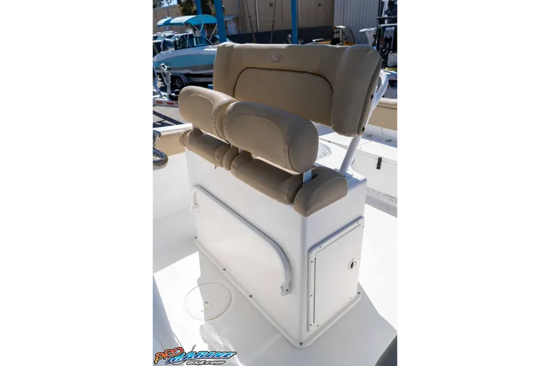 Slide: The Image of 2017 Sea Hunt Ultra 235 SE boat seating with beige cushions and storage compartment. - 24