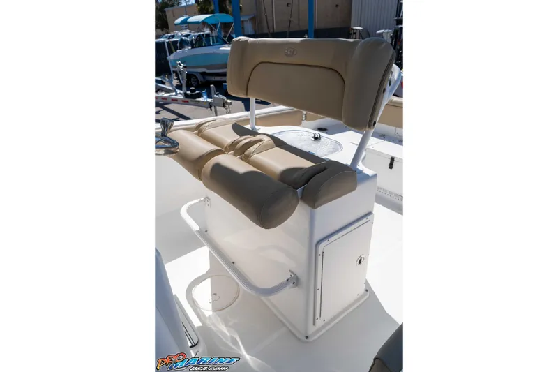 Slide: The Image of 2017 Sea Hunt Ultra 235 SE boat seating with beige cushions and storage compartment. - 25