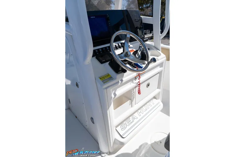 Slide: The Image of 2017 Sea Hunt Ultra 235 SE boat console with steering wheel and controls. - 27