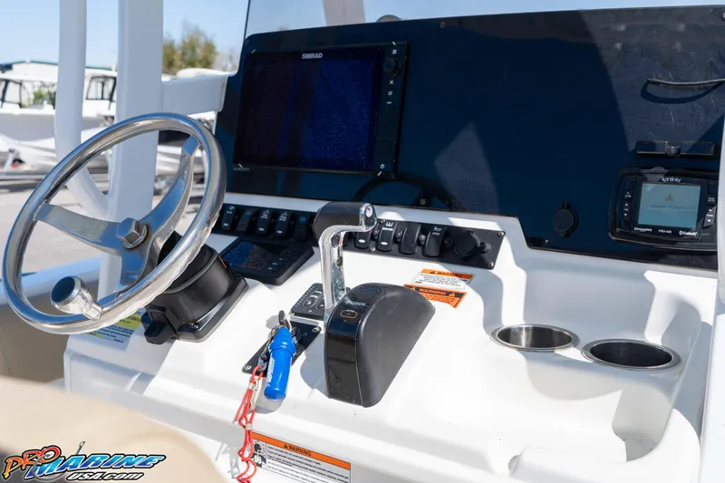 Slide: The Image of 2017 Sea Hunt Ultra 235 SE boat dashboard with steering wheel and navigation controls. - 28
