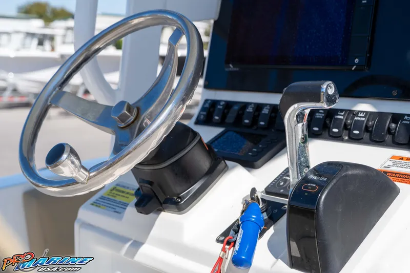 Slide: The Image of Steering wheel and controls of 2017 Sea Hunt Ultra 235 SE boat cockpit. - 29
