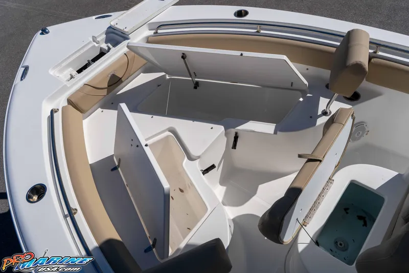 Slide: The Image of 2017 Sea Hunt Ultra 235 SE boat interior with open storage compartments and seating. - 31
