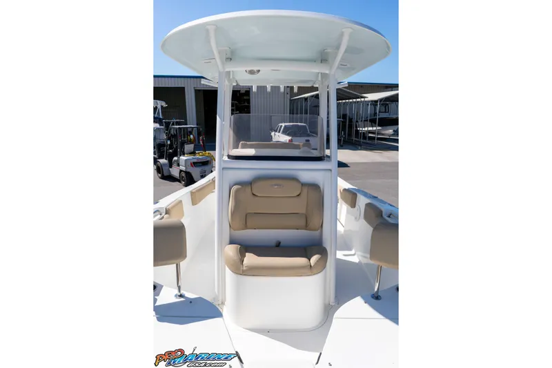 Slide: The Image of 2017 Sea Hunt Ultra 235 SE boat interior with tan seating and T-top. - 32