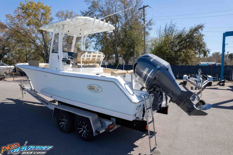 Slide: The Image of 2017 Sea Hunt Ultra 235 SE boat on trailer with Yamaha engine, parked outdoors. - 47