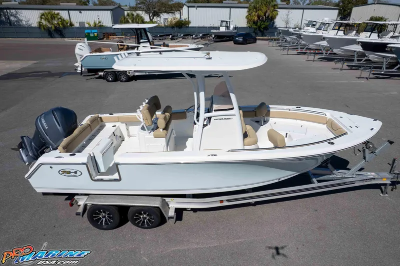 Slide: The Image of 2017 Sea Hunt Ultra 235 SE boat on trailer, parked in a marina lot. - 58