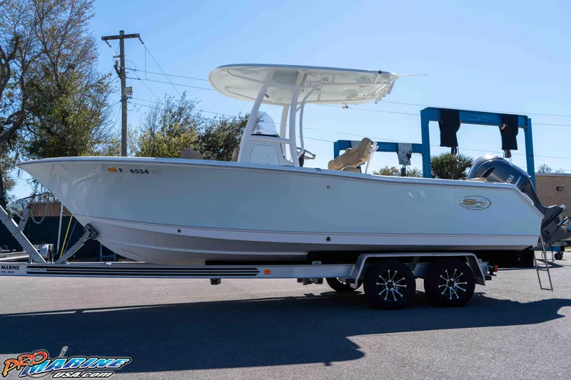 Slide: The Image of 2017 Sea Hunt Ultra 235 SE boat on trailer, side view in outdoor setting. - 8