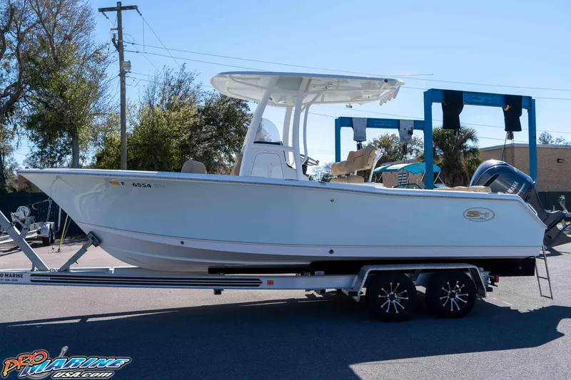 Slide: The Image of 2017 Sea Hunt Ultra 235 SE boat on trailer, parked outdoors. - 9