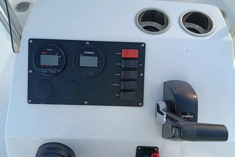 Slide: The Image of 2026 Frontier 180 boat seat with white cushion and metal frame, near a serene pond. - 15