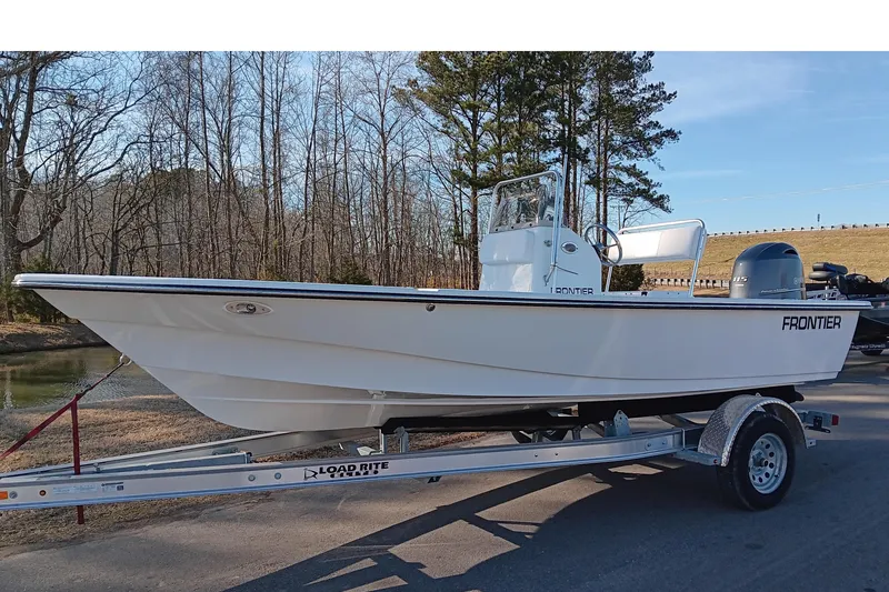 Slide: The Image of 2026 Frontier 180 boat displayed outside Collins, Inc. dealership under a cloudy sky. - 3
