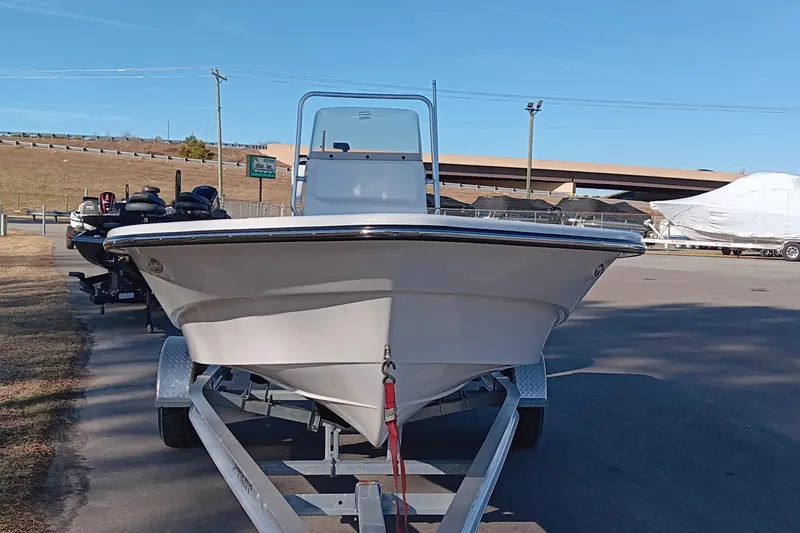 Slide: The Image of 2026 Frontier 180 boat on trailer, parked outdoors under cloudy sky. - 4