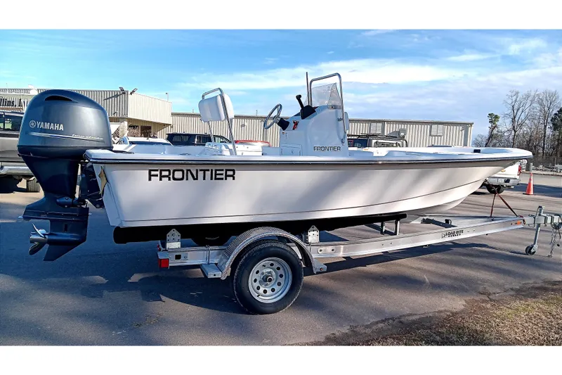Slide: The Image of 2026 Frontier 180 boat with outboard motor on trailer in parking lot. - 7