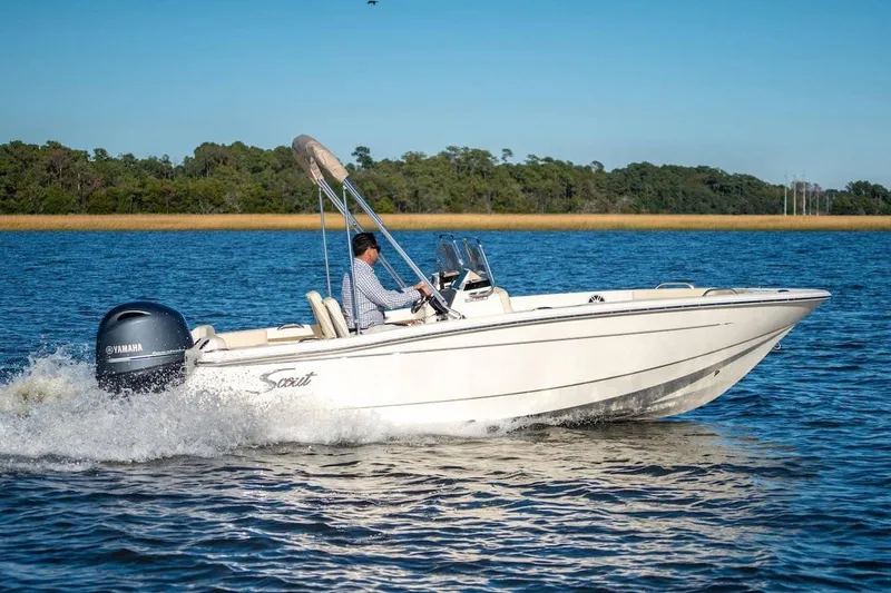 Slide: The Image of 2026 Scout 188 Sport Dorado boat cruising on a serene lake with Yamaha engine. - 13