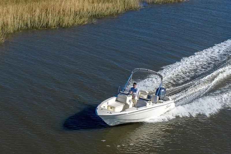 Slide: The Image of 2026 Scout 188 Sport Dorado boat cruising on a calm waterway. - 9